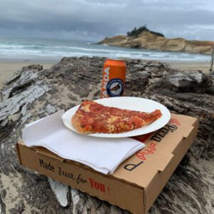 Doryland Pizza and Pelican beer on the beach